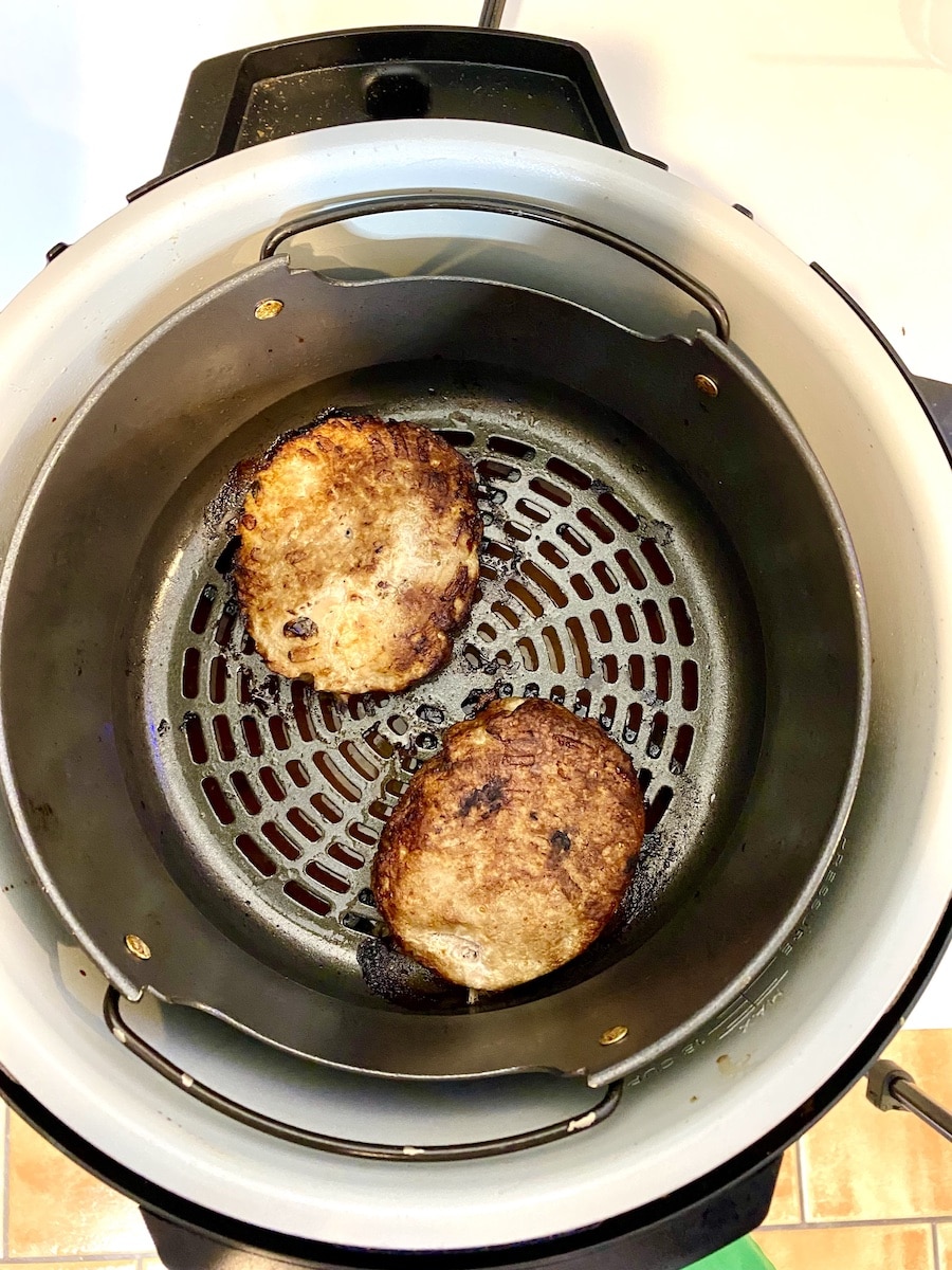 two turkey burgers fully cooked in the air fryer